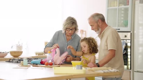 Loving Grandparents Helping Granddaughter Pack School Lunch Box