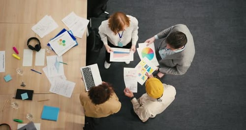 Diverse Professionals Engage in Dynamic Discussion in Office