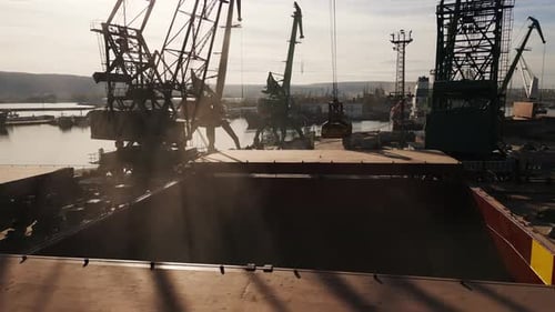 Aerial View of Big Cargo Ship Bulk Carrier is Loaded with Grain of Wheat in Port at Sunset