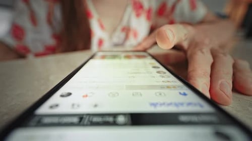 Woman Scrolling Through Social Media on Smartphone