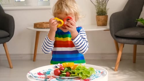 Cute Child Playing with Colorful Vegetables