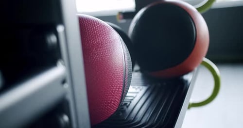 CloseUp of Medicine Balls Lined on Rack in Modern Gym
