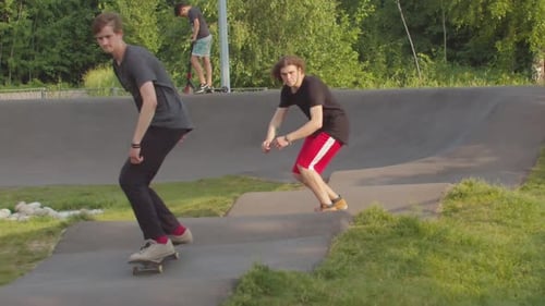 Two Young Men Skateboarding in the Park on Special Wavy