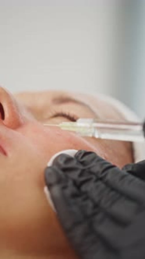 Woman Getting Facial Injection in Clinic Setting