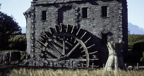 Historic Watermill By a Field Under a Clear Sky in a Rural Landscape