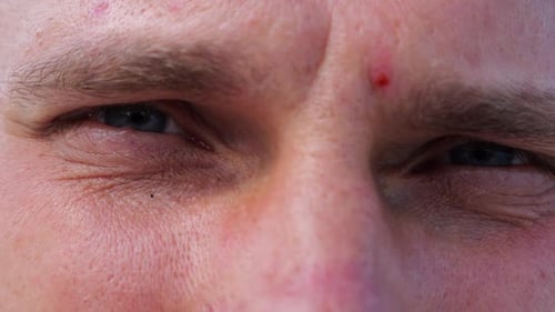 Close Up to Upset Male Face Looking Into Camera with a Disappointing Sight Upset Facial Expression