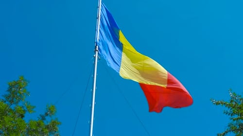 Waving Romanian Flag Displaying National Pride on a Flagpole