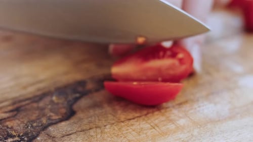 The Woman Cuts Tomatoes