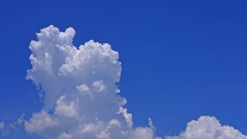 White Clouds Drifting Across a Vibrant Blue Sky