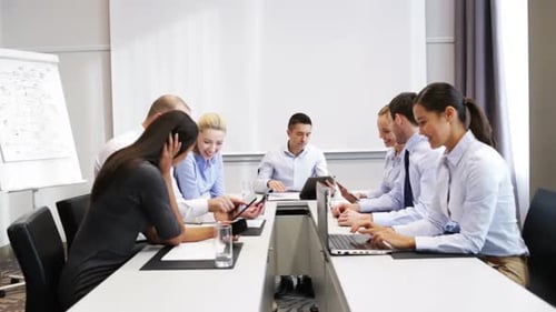 Business Meeting with Team Using Digital Devices