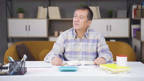 Man Working At Desk At Home Office