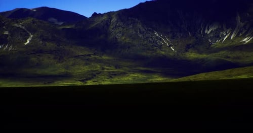 Mountain Landscape Under Bright Blue Sky with Contrasting Shadows