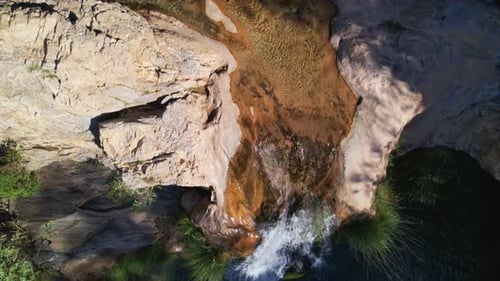 Waterfall and stream with showy turquoise waters. Reaviling aerial view. Green river. Granada. Spain