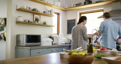Couple Tasting Food Together in Modern Kitchen