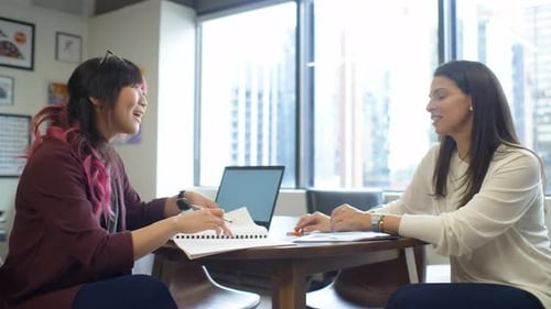 Businesswomen Planning Talking In Meeting In Highrise Office