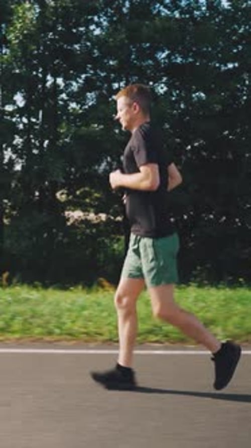 Young Man Running in Morning in Summer Runner Run Active Confident Hardy Man Running Side View