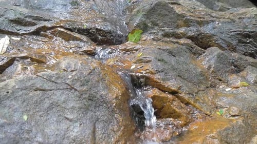 a small waterfall flowing down the stones.