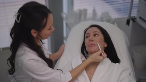 Woman Receives Facial Treatment in Bright Medical Clinic