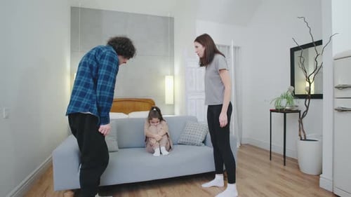 Parents Arguing in Front of Child on Couch