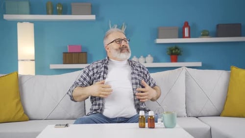 Man Experiencing Discomfort While Sitting on Sofa
