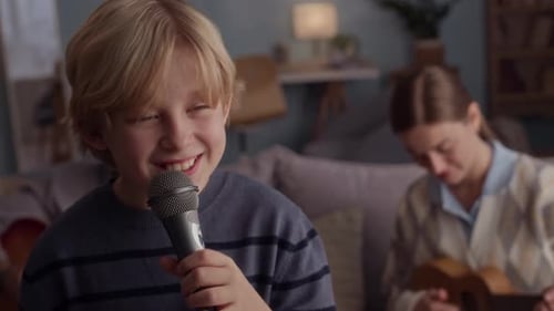 Boy Sings with Family Playing Instruments at Home