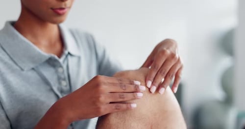 Therapist Massages Knee in Medical Setting