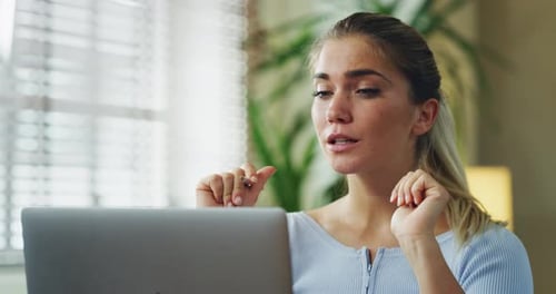 Woman Chatting on Video Call with Laptop at Home