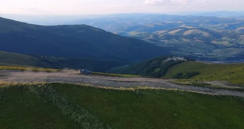 Aerial View of a Car Driving on a Mountain Road Concept of Mountainous Terrain