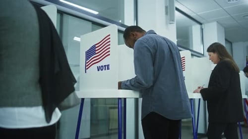African American Man Comes to Vote in Booth in Polling Station