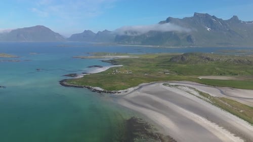 Enjoy a Droneshot of a Tranquil Coastal Beach with Breathtaking Mountain Views Lofoten Norway