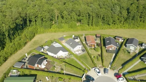 Small Strips of Green Grass, Houses Built Closely together in Unique Circular Community near Forest