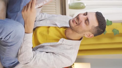 Young Adult Reviewing Documents on Sofa