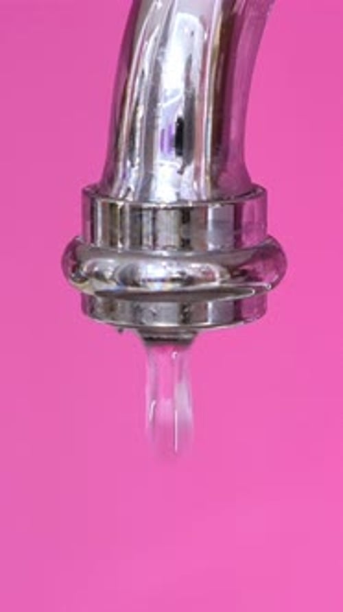 Modern Faucet with Running Water at Apartment with Pink Walls Nobody Vertical