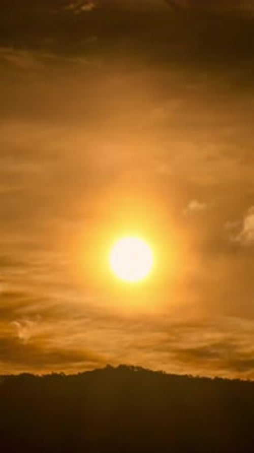 Golden Sunrise Behind Silhouetted Hills at Dawn