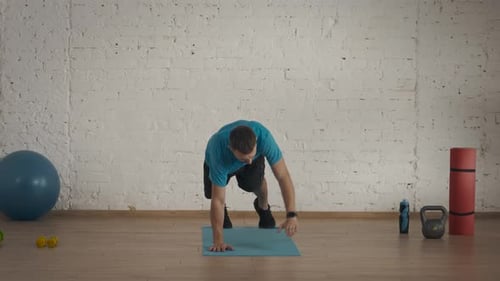 Man Fitness Coach in Sportswear Doing Active Plank Exercise for Online Class at the Home Studio