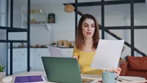 Young Woman Working from Home on Laptop