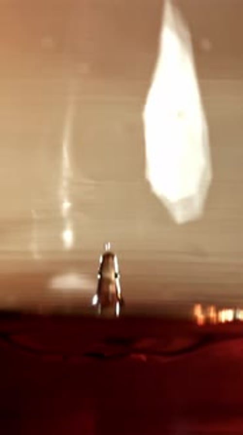 A Drop Falls Into a Glass of Cognac Filmed on a Highspeed Camera at 1000 Fps