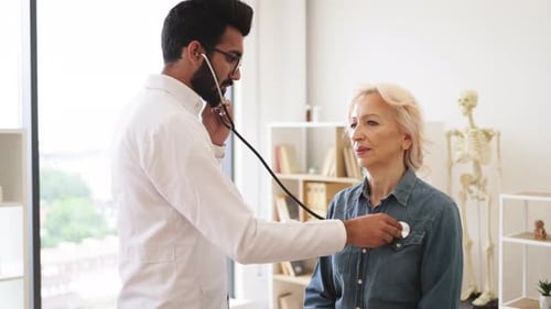Doctor Examines Patient With Stethoscope in Clinic