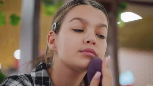 Teenage Girl Applies Makeup With Sponge