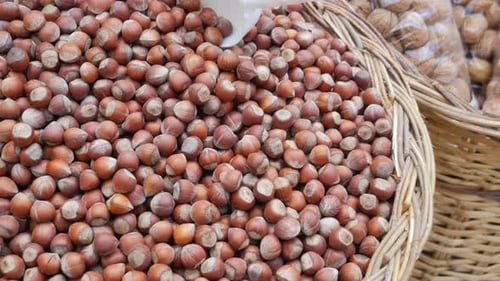 Fresh and Natural Hazelnuts Are Beautifully Arranged in Baskets at a Vibrant Local Market