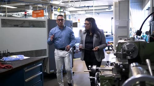 Manager Giving Tour to Visitor in Manufacturing Plant 10 Seconds or Greater