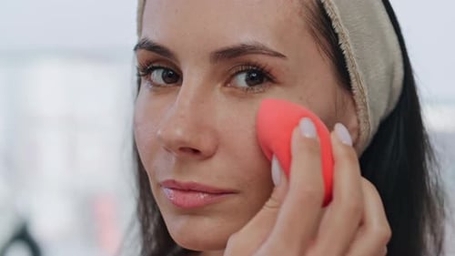 Attractive Woman Applies Makeup With Beauty Blender