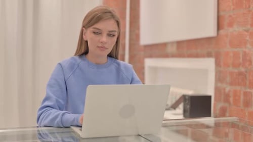 Woman Working on Laptop in Modern Home Office