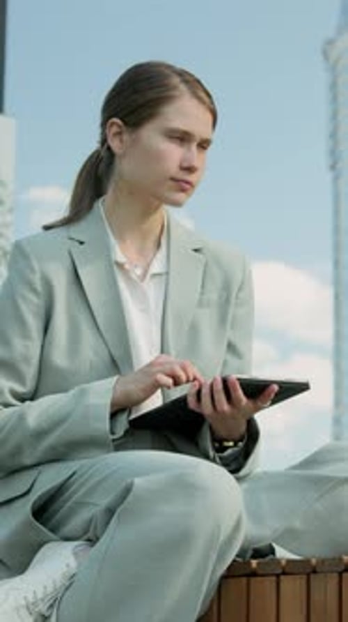Woman Using Tablet in Urban Environment