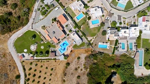 Top down drone shot rotating above a holiday resort, sunny day in Greece