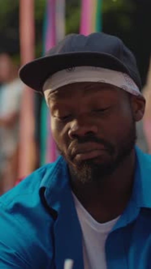 Man Smiles and Enjoys Refreshing Beverage Outdoors