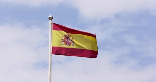 Spanish Flag Waving Proudly against Sky