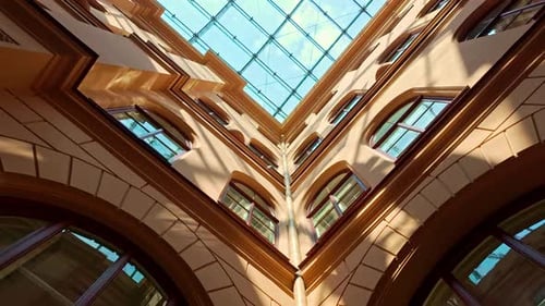 Architectural Interior with Glass Roof and Arched Windows