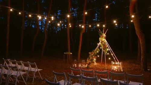 Festive String Lights Illumination on Boho Tipi Arch Decor on Outdoor Wedding Ceremony Venue in Pine