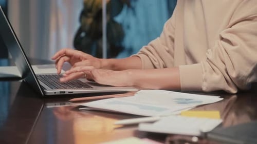 Young Adult Working at Desk Using Laptop